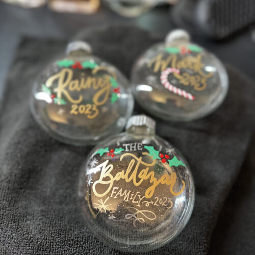 Glass holiday ornament with custom calligraphy of a family name