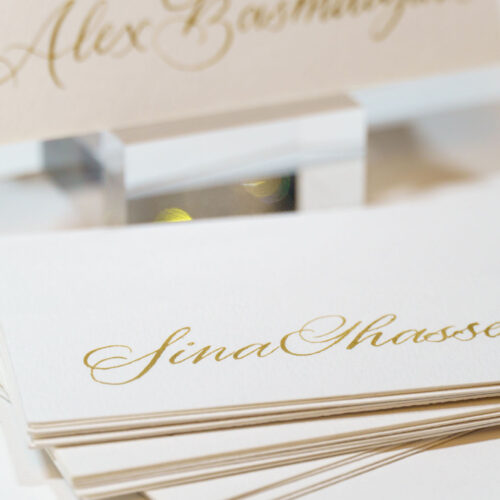 Close-up of hand-written gold calligraphy on wedding name cards by KeeKee Creates.