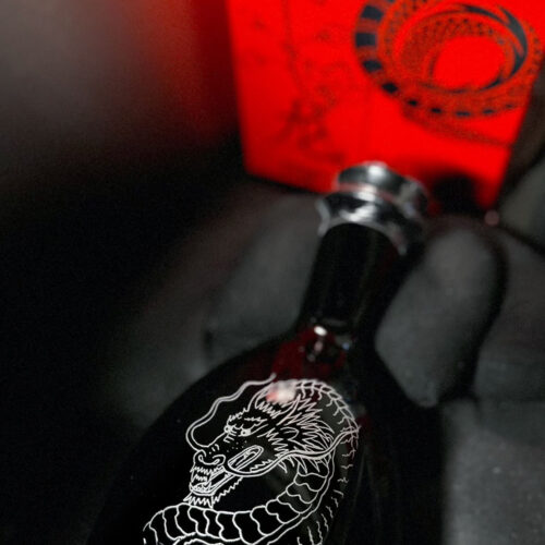 Hand-engraved D'USSÉ bottle by KeeKee Creates with a dragon for Lunar New Year.