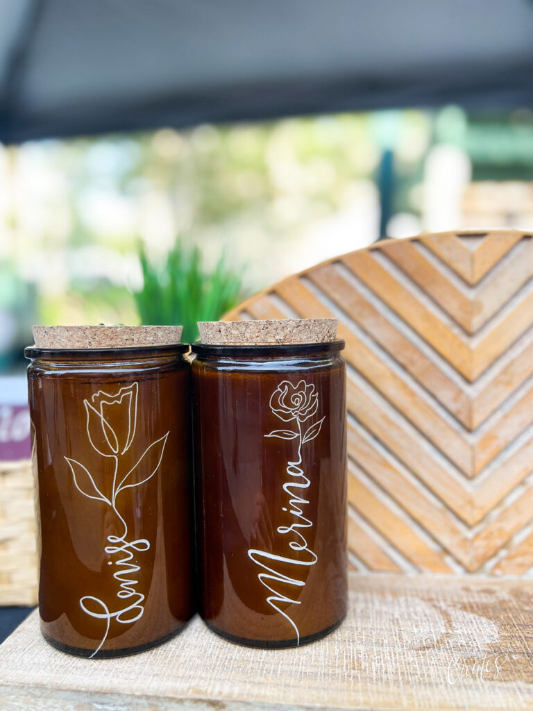 Engraved candles by KeeKee Creates with floral designs and names."