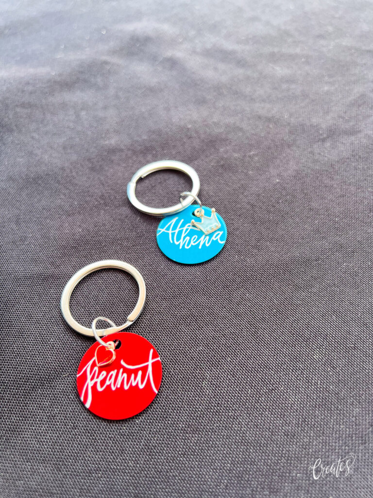 Engraved metal pet tags by KeeKee Creates with pet names.