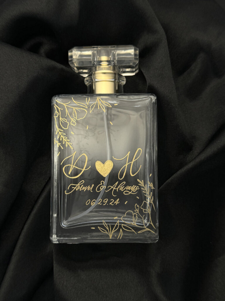 Engraved refillable bottle for a wedding with floral embellishments by KeeKee Creates.