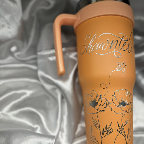 Engraved orange water bottle travel mug by KeeKee Creates with name and poppy bee design.