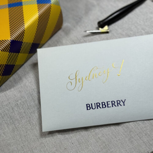 Burberry envelope with 'Sydney!' in gold calligraphy