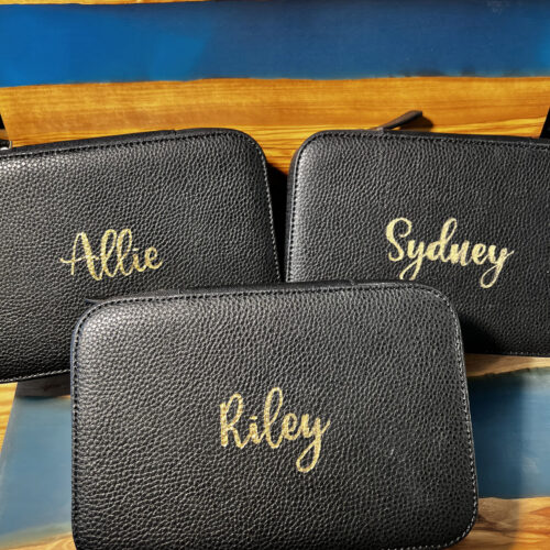 Custom black leather pouches with 'Allie', 'Sydney', and 'Riley' engraved in gold foil by KeeKee Creates