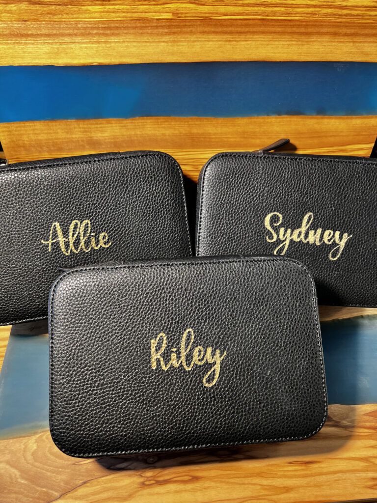 Custom black leather pouches with 'Allie', 'Sydney', and 'Riley' engraved in gold foil by KeeKee Creates
